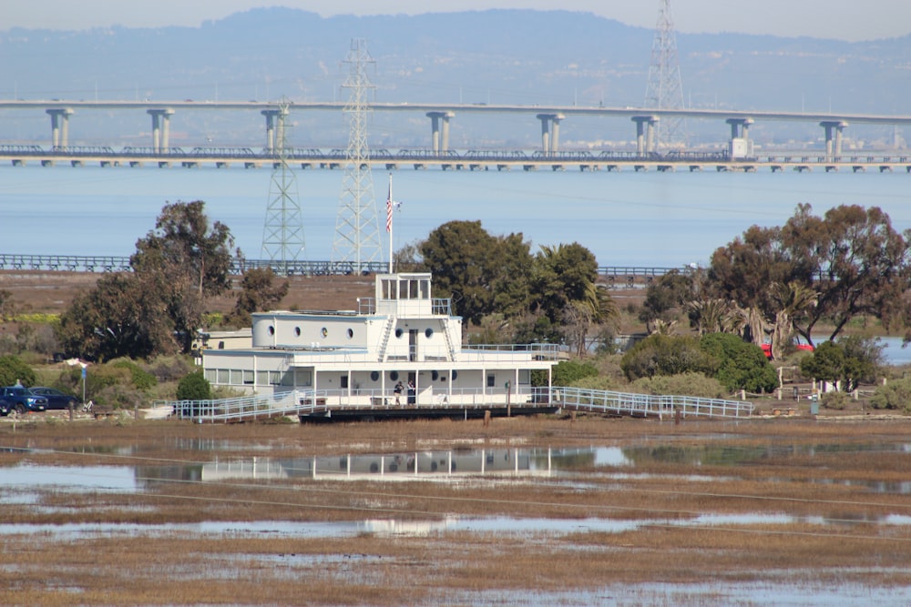 a large white boat sitting on top of a lake