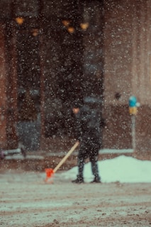 a person with a shovel in the snow
