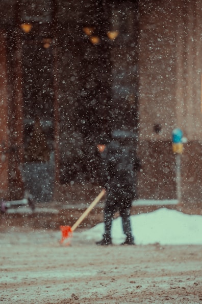 a person with a shovel in the snow