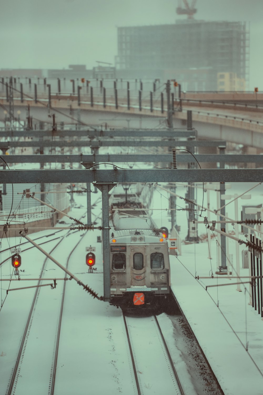 a train traveling down train tracks in the snow