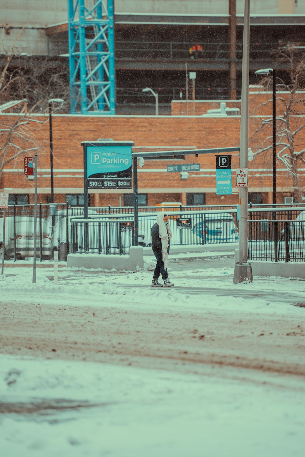 a person walking down a street in the snow