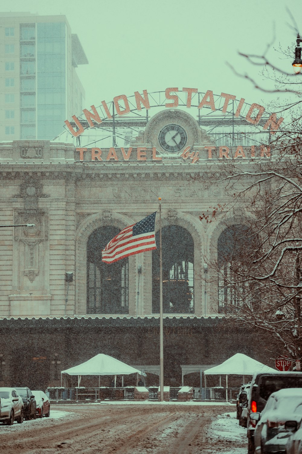 a train station with a flag flying in front of it