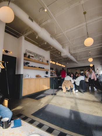 A cozy interior of the cafe with happy patrons.