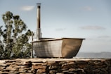 Outdoor hot water tinaja with mountain backdrop and evening light