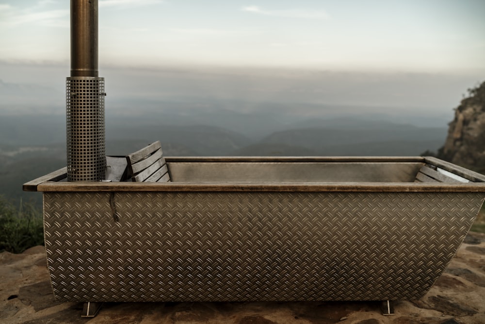 a large metal tub sitting on top of a mountain