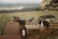 Cozy outdoor braai area with mountain backdrop at dusk.