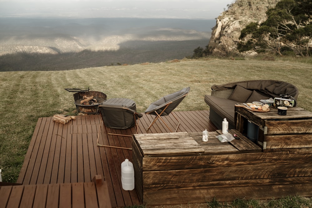 a wooden deck with chairs and a table on it