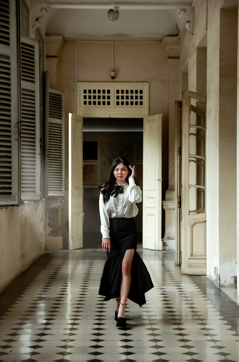 a woman in a black skirt and white shirt