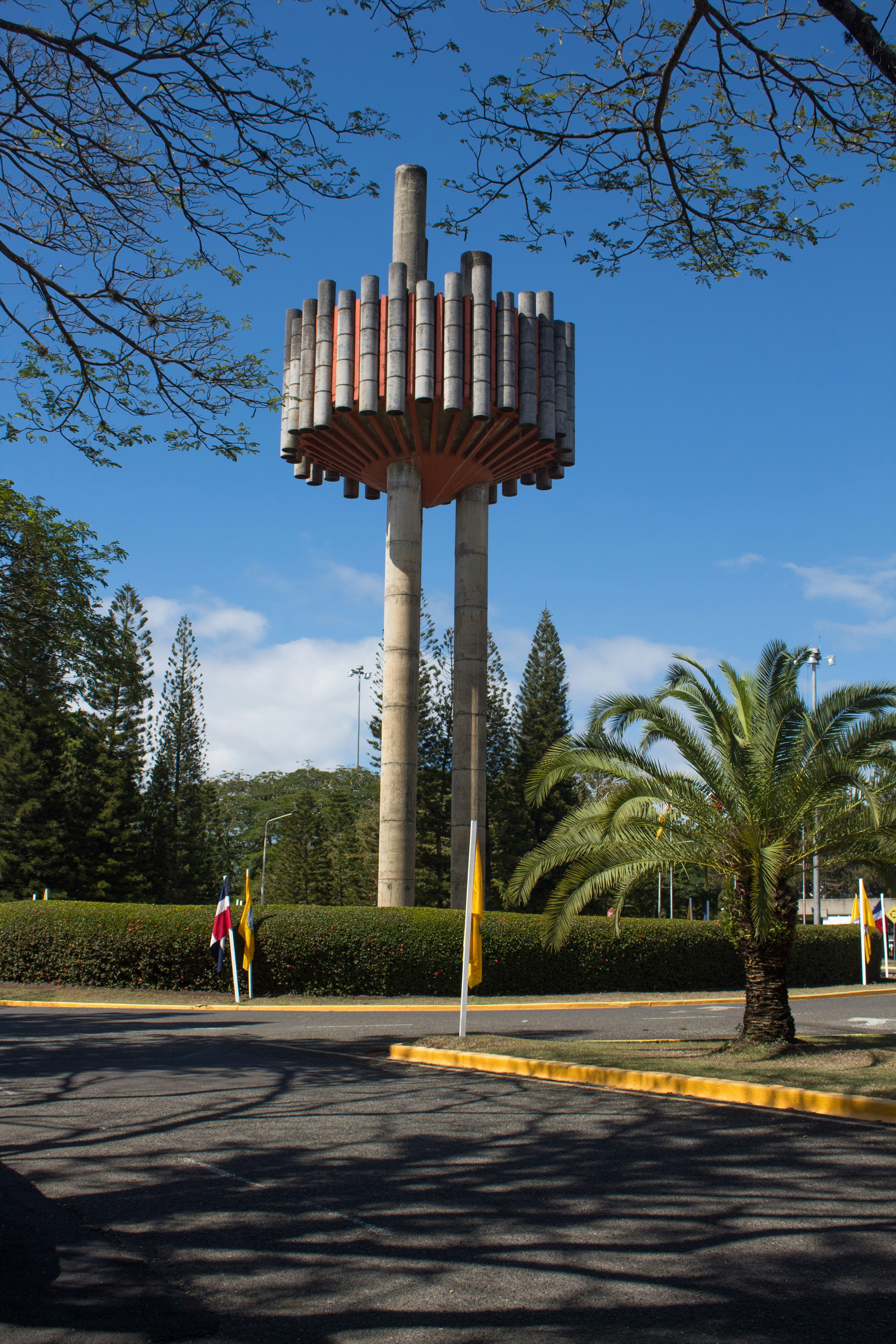a tall tower with a bunch of pipes on top of it