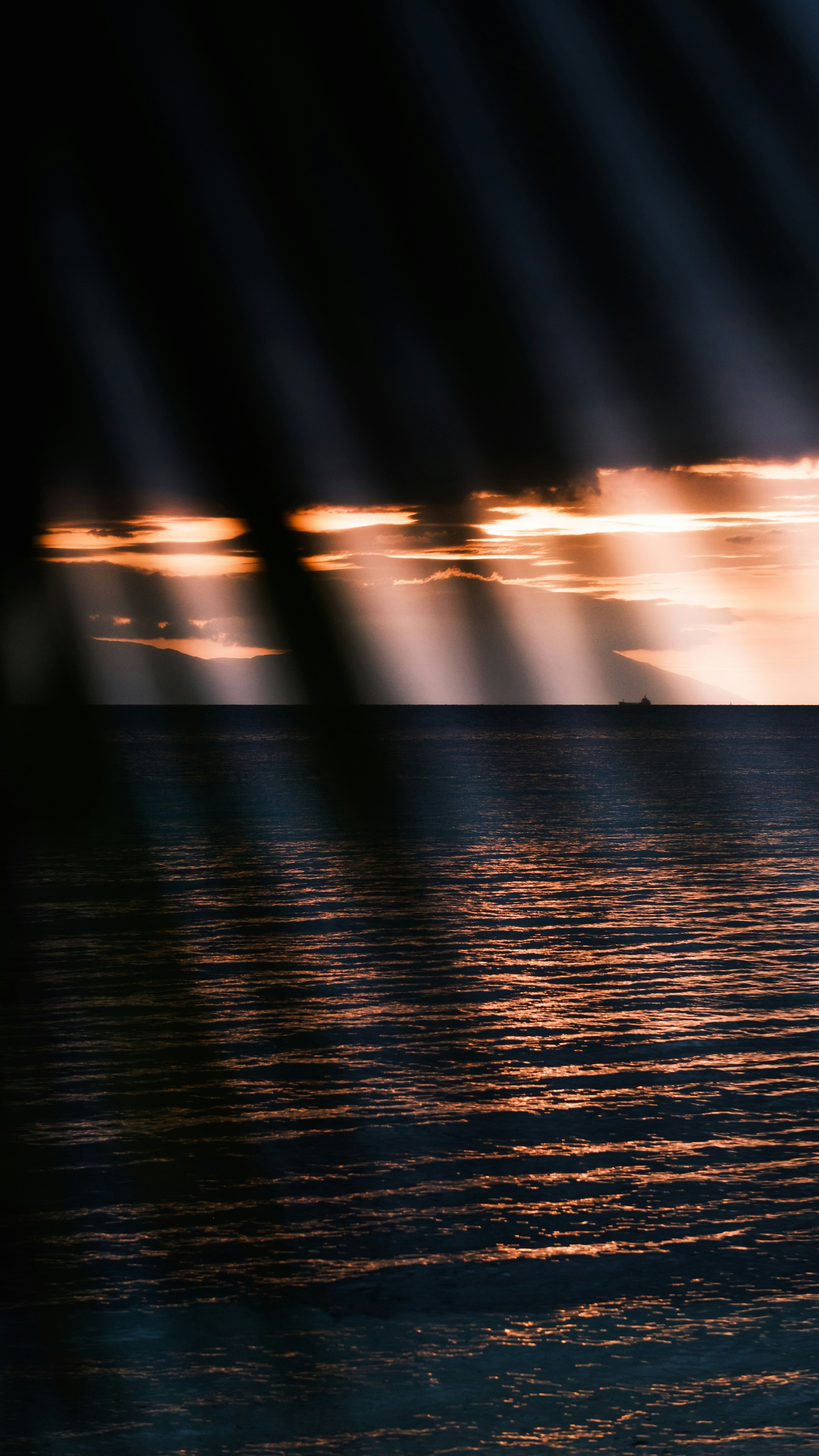 a large body of water under a cloudy sky