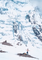 a man standing on top of a snow covered mountain