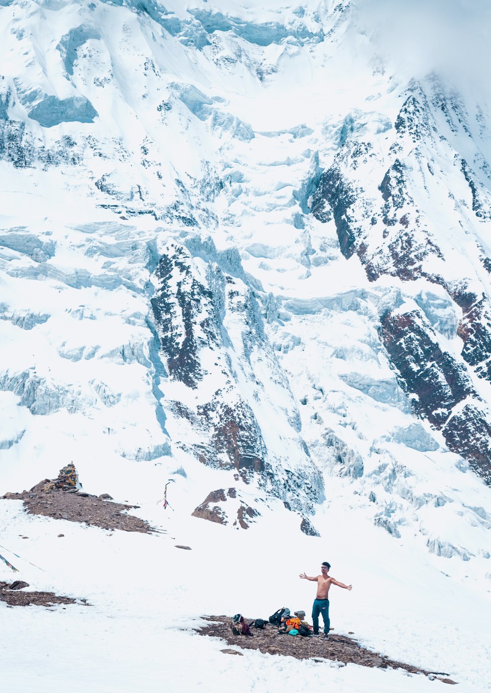 a man standing on top of a snow covered mountain