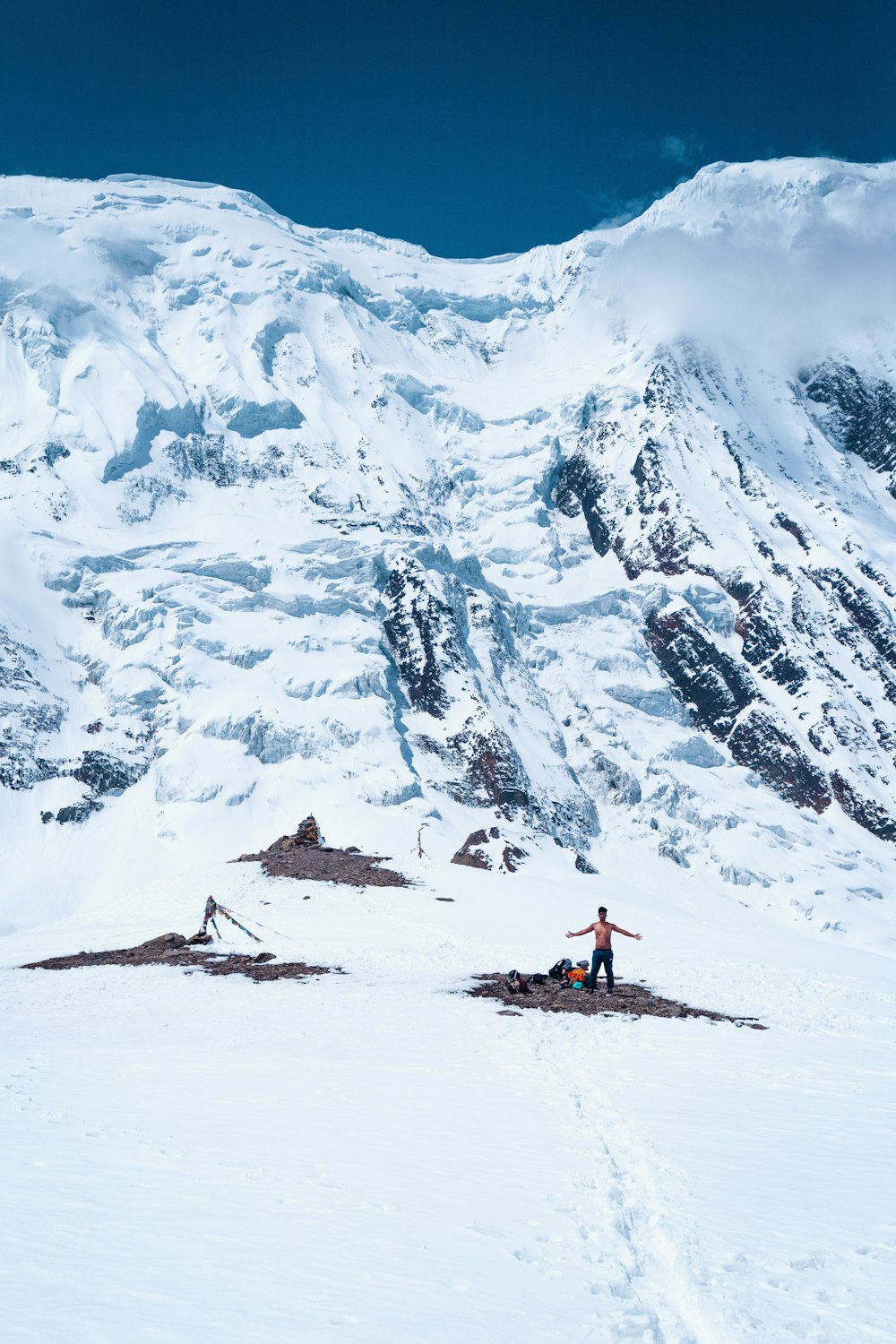 a man standing on top of a snow covered mountain