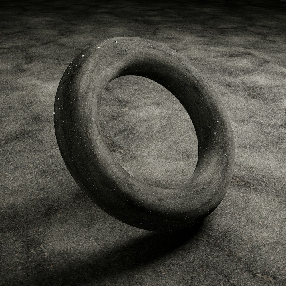 a black and white photo of a tire on the ground