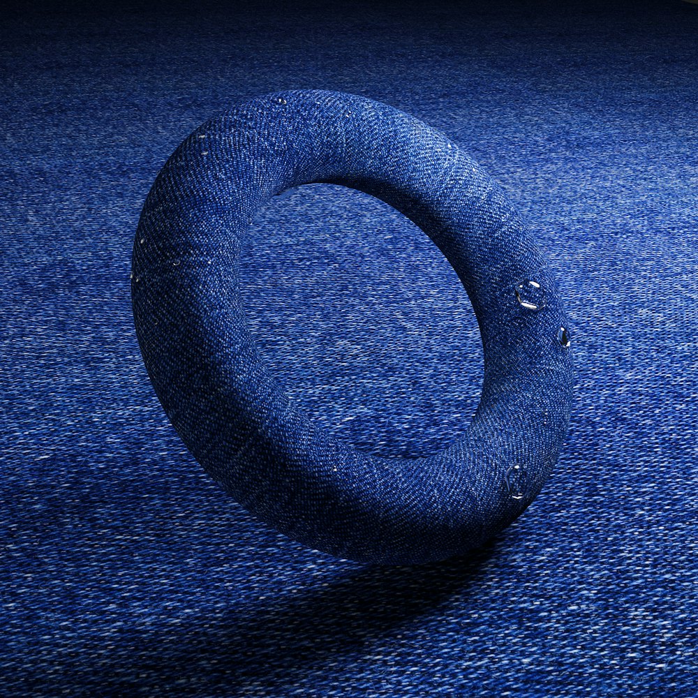 a blue carpet with a circular object on top of it