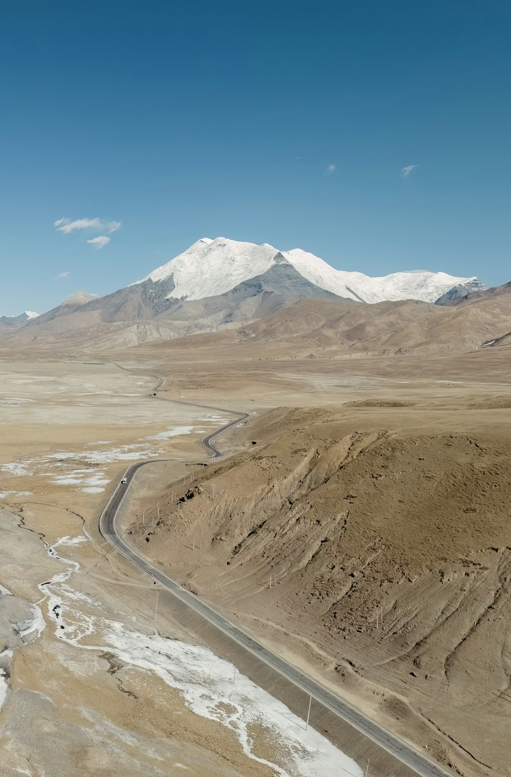 an aerial view of a road in the desert