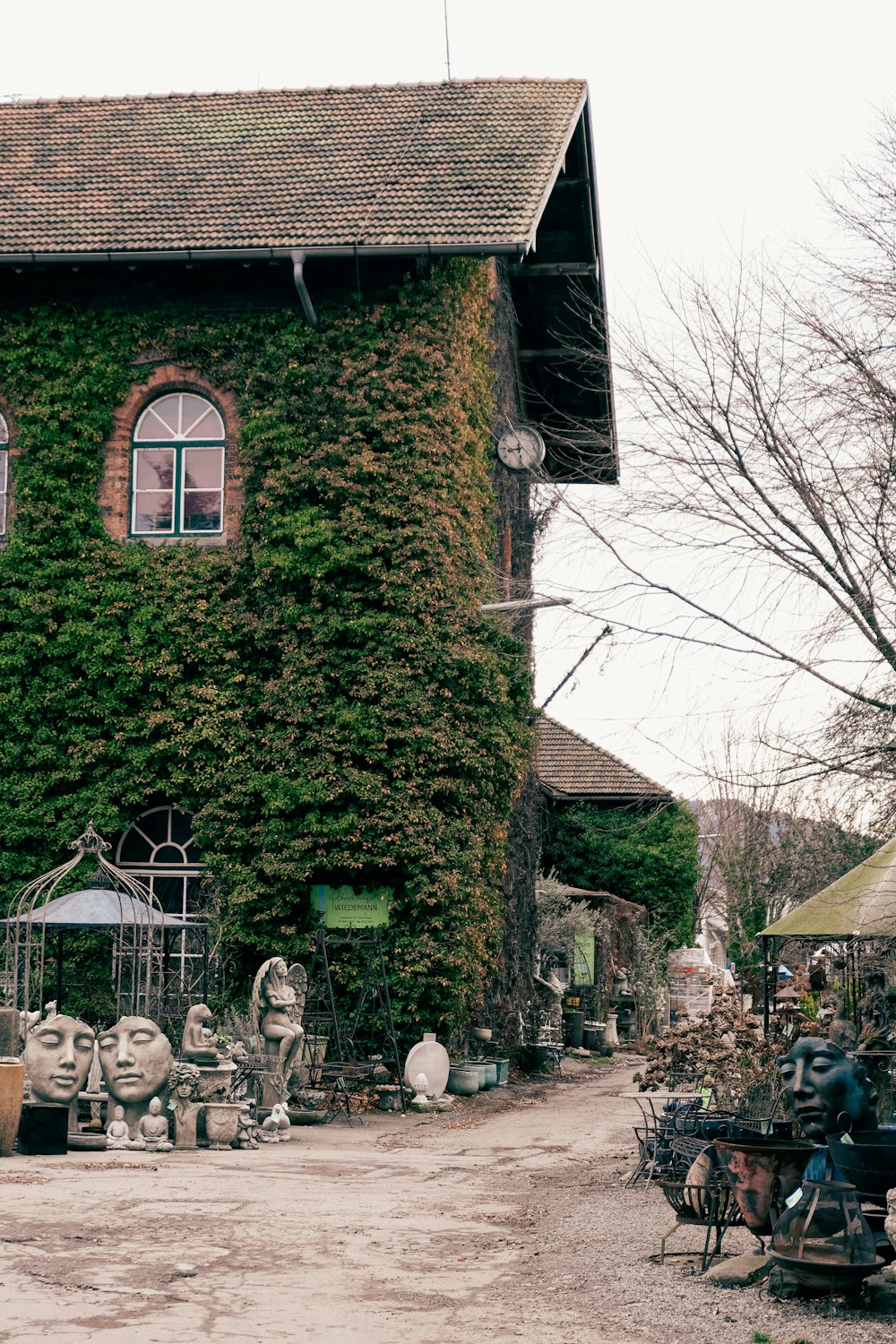 a large building covered in vines with a motorcycle parked in front of it