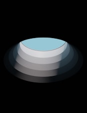 a round object with a blue center on a black background