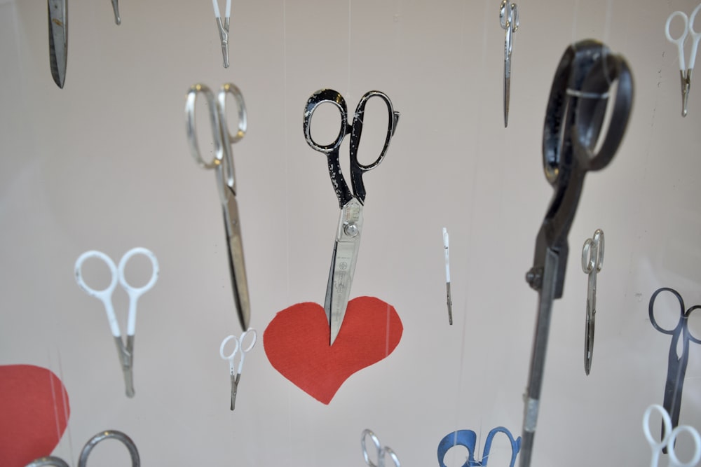 scissors and a heart hanging on a wall