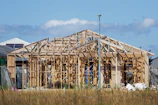 a house under construction in the middle of a field