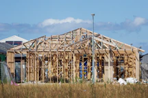 a house under construction in the middle of a field