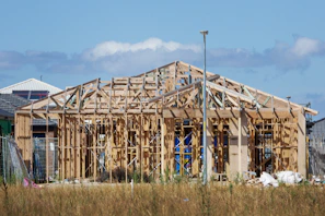 a house under construction in the middle of a field