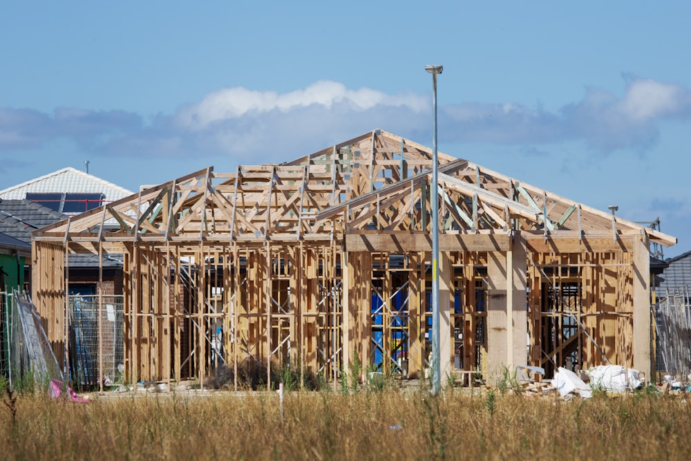 a house under construction in the middle of a field