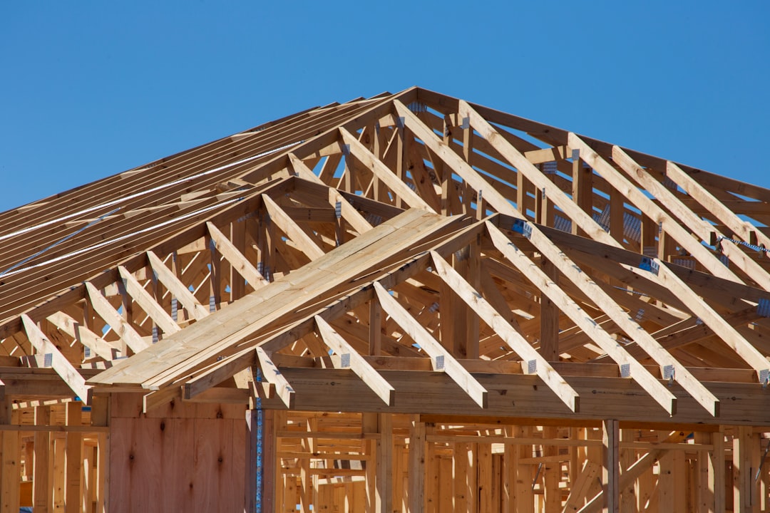 a house under construction with wooden framing, New home building – Timber and roof trusses.