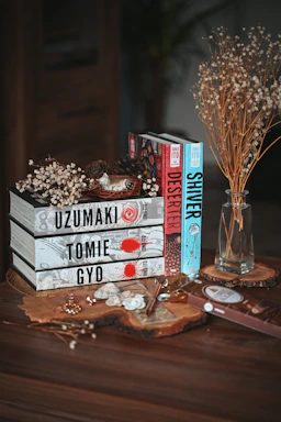 A collection of limited edition manga collectibles displayed on a wooden shelf.