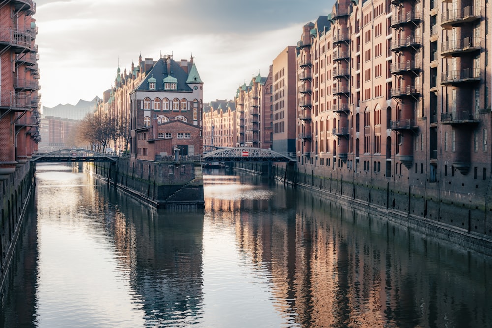 a river running through a city next to tall buildings