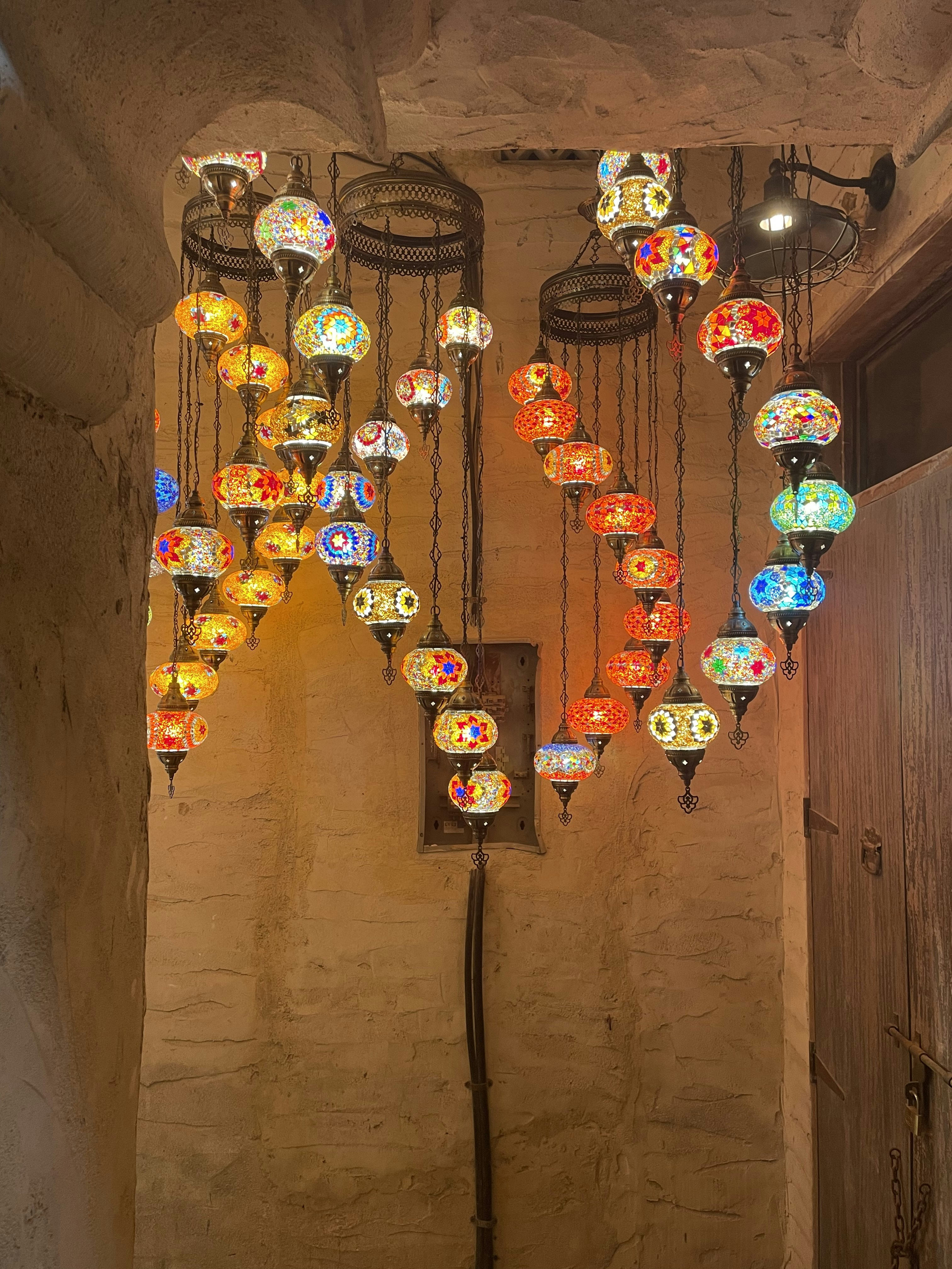 A bunch of colorful lights hanging from a ceiling photo – Free Light ...
