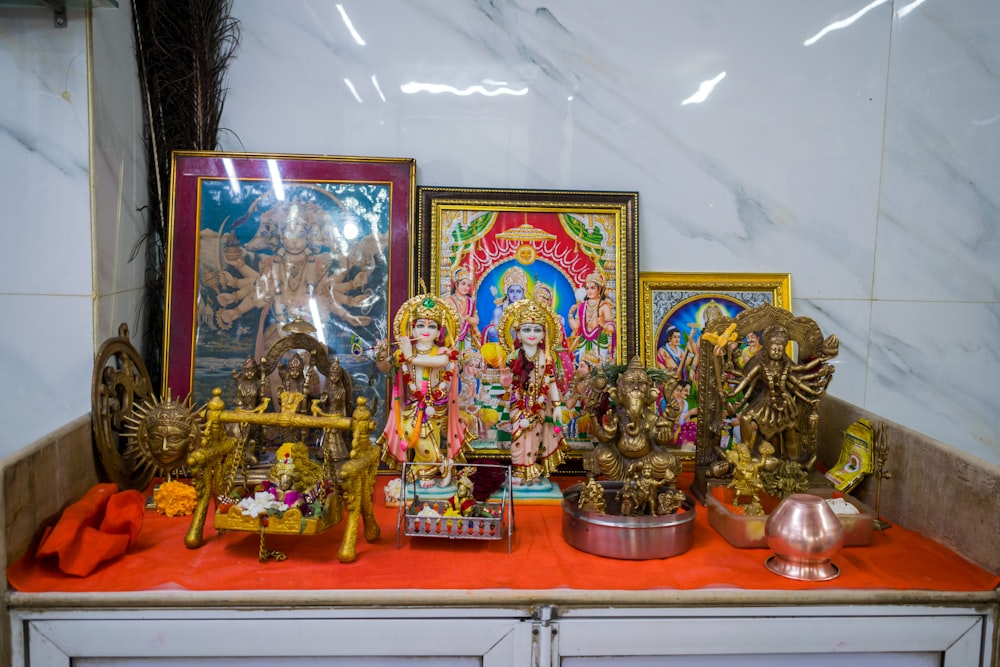 a bunch of statues on a table in a room