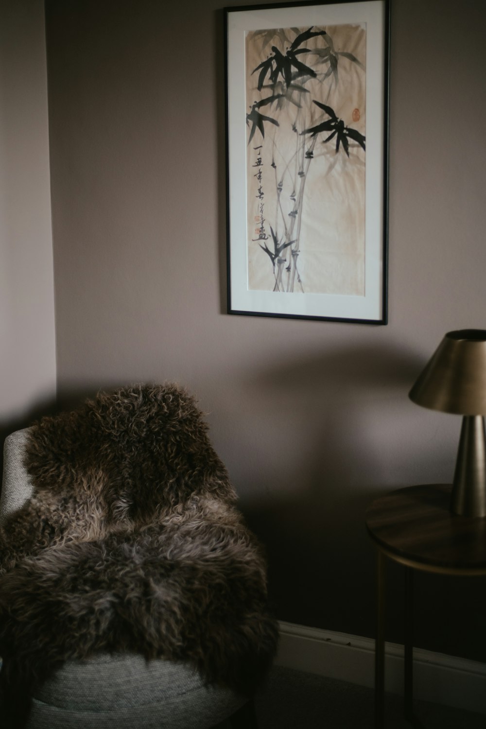 a chair in a room with a picture on the wall