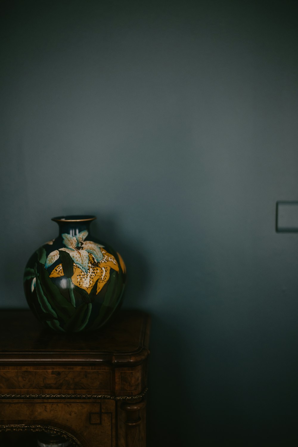 a vase sitting on top of a wooden table