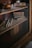 An elegant bookshelf filled with romance novels in soft lighting.