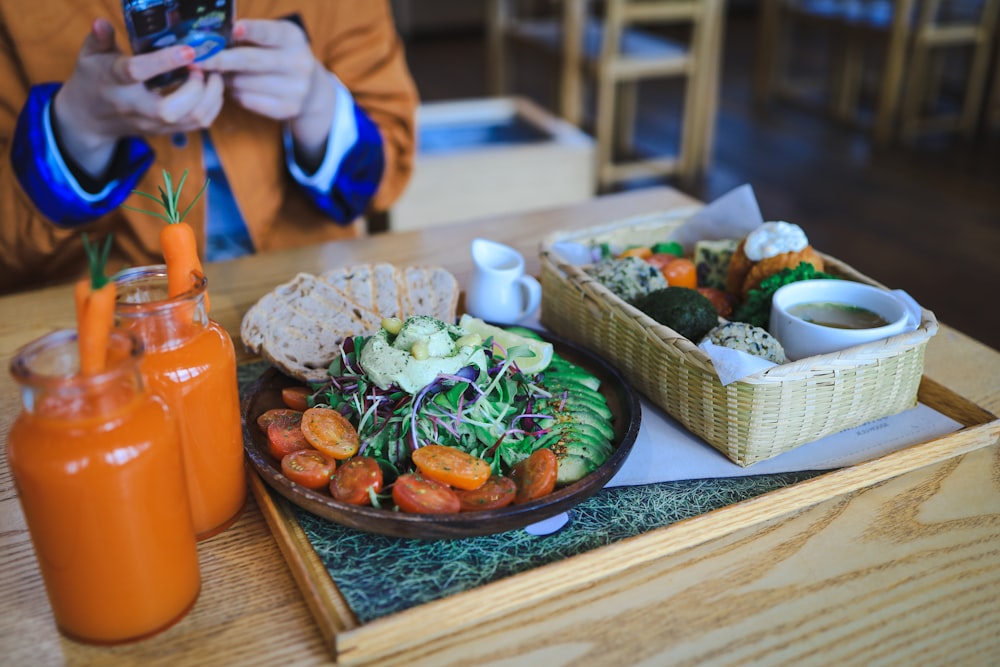 a person taking a picture of a plate of food