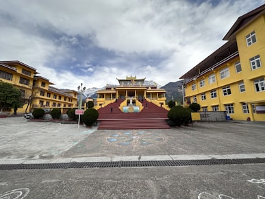 a yellow building with a red staircase in front of it