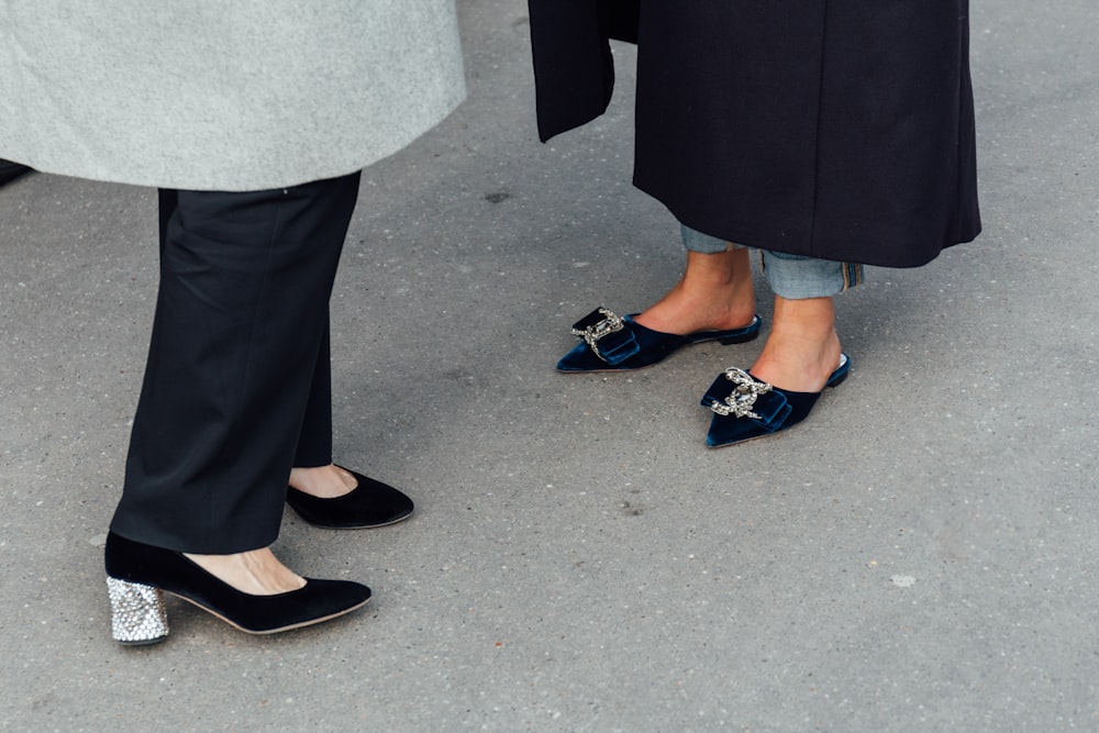 two people standing next to each other wearing blue shoes