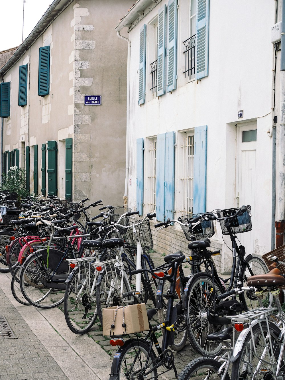 a row of bicycles parked next to a building