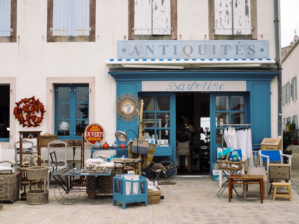 a store front with a lot of furniture outside of it