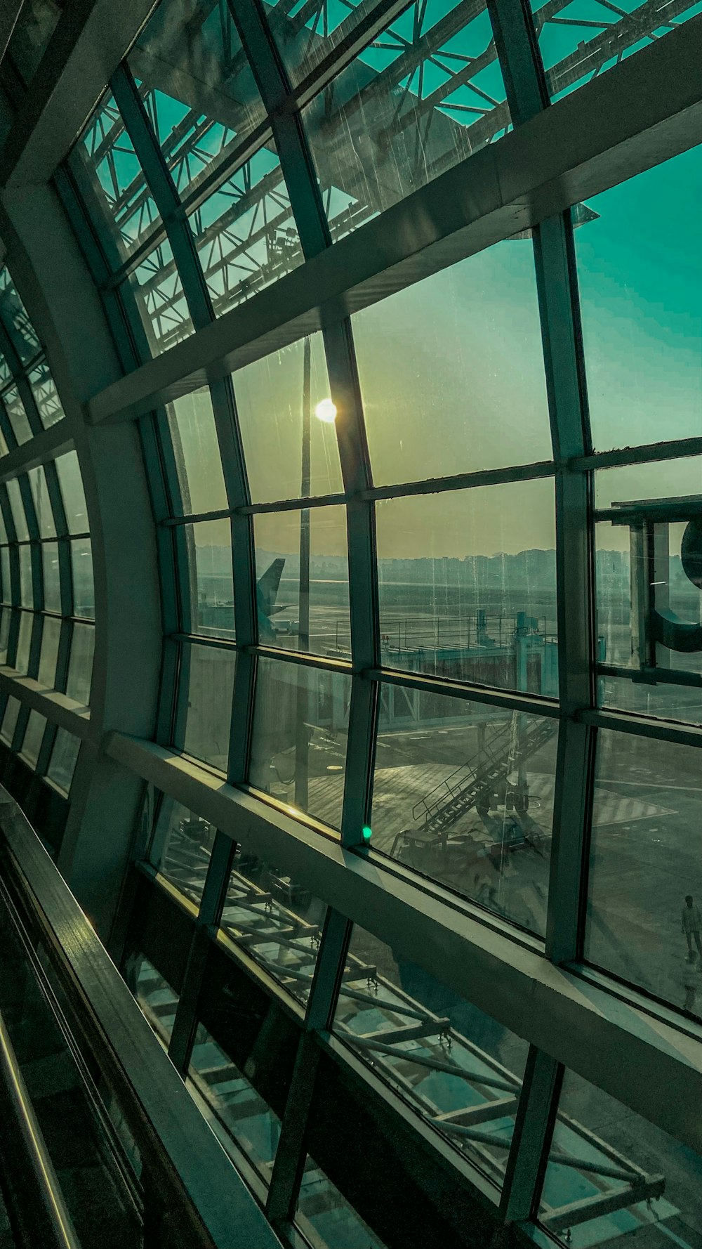 the sun is shining through the windows of an airport