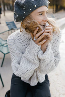 A stylish model wearing a cozy knitted beret outdoors on a crisp autumn day.