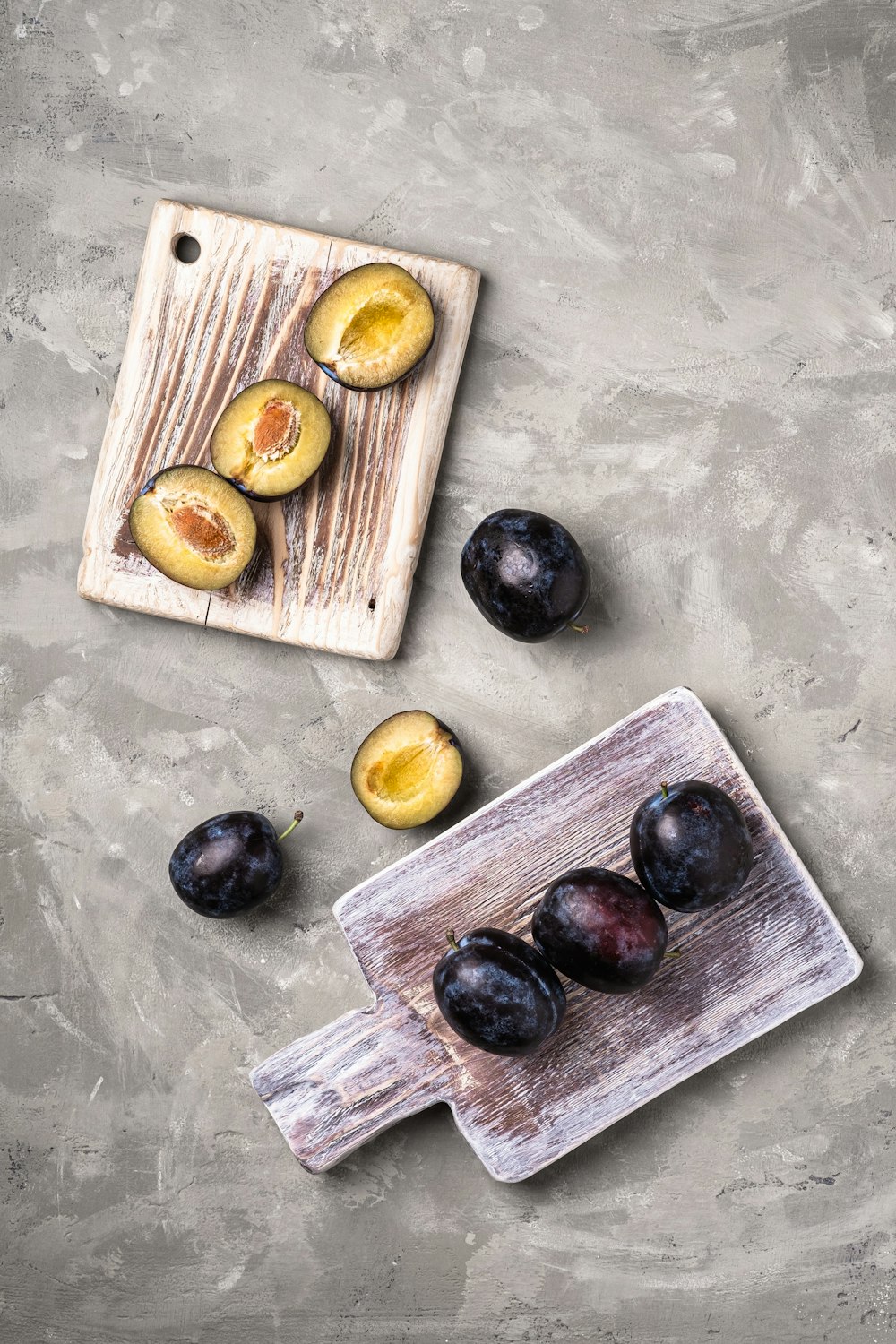 a cutting board topped with sliced plums next to a knife