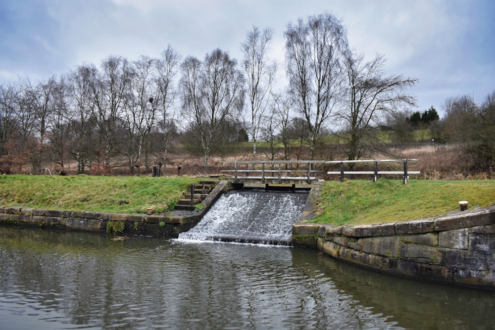 a small waterfall in the middle of a park