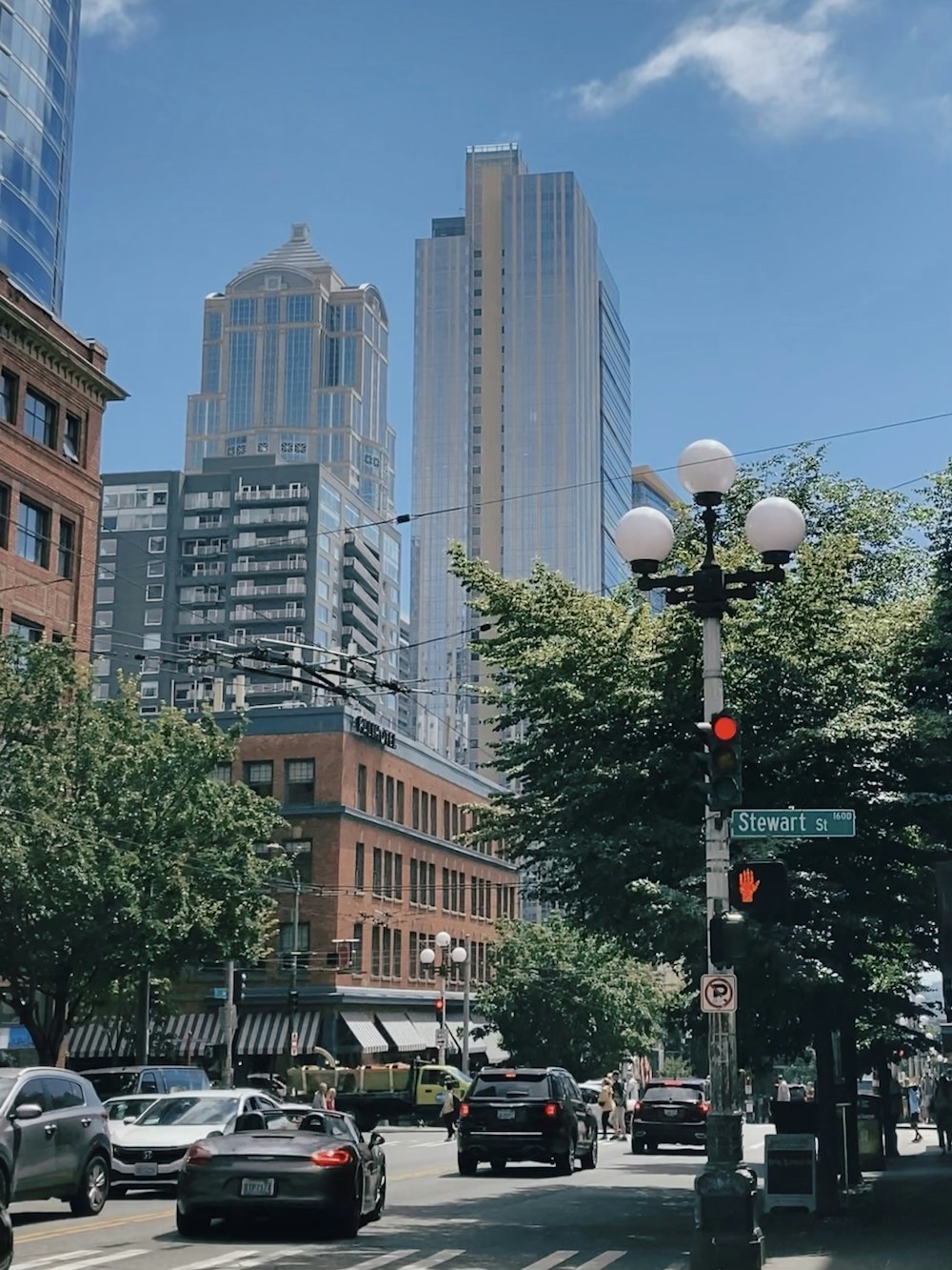 a city street filled with lots of traffic and tall buildings