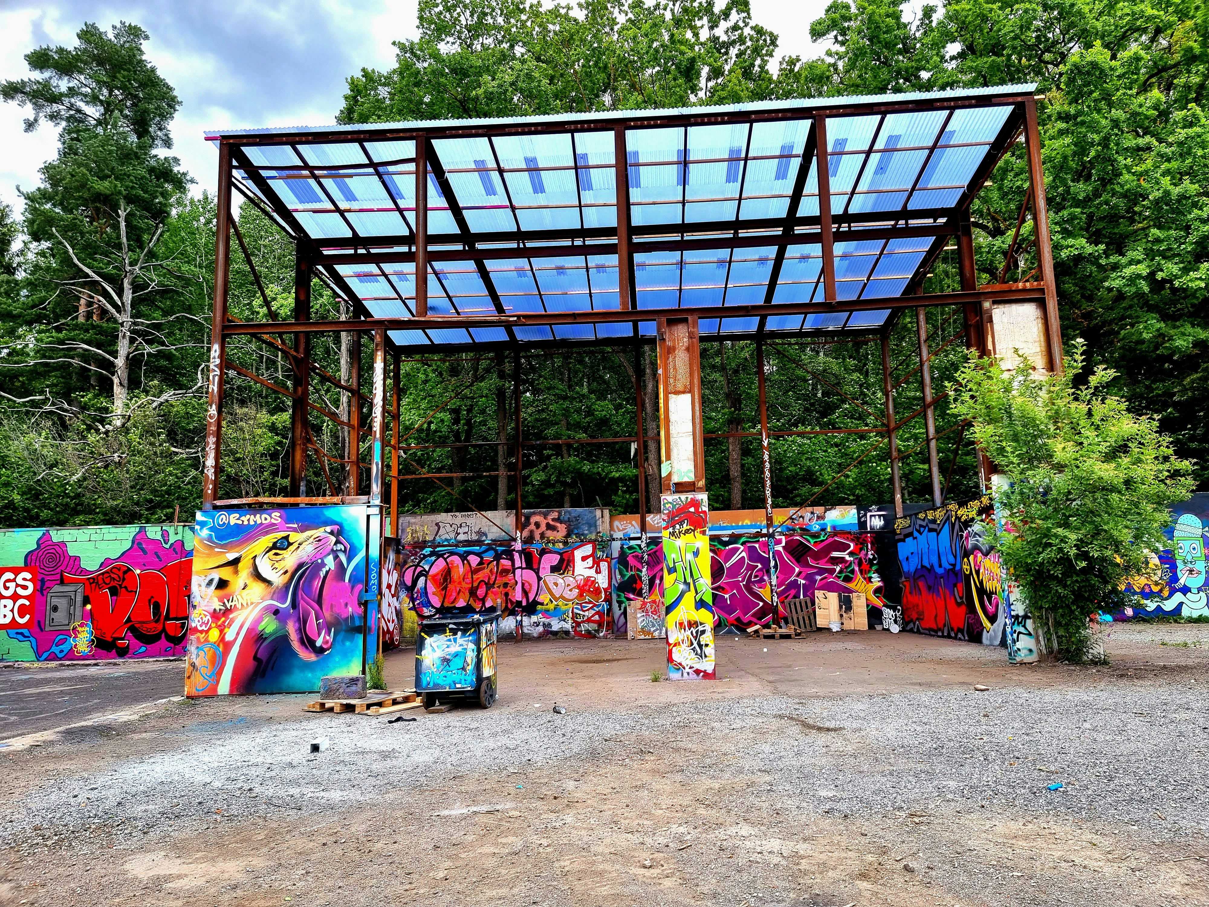 a covered area with graffiti on the walls