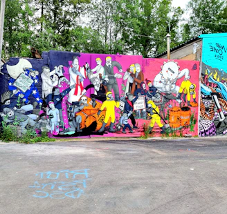 a bunch of graffiti on the side of a building