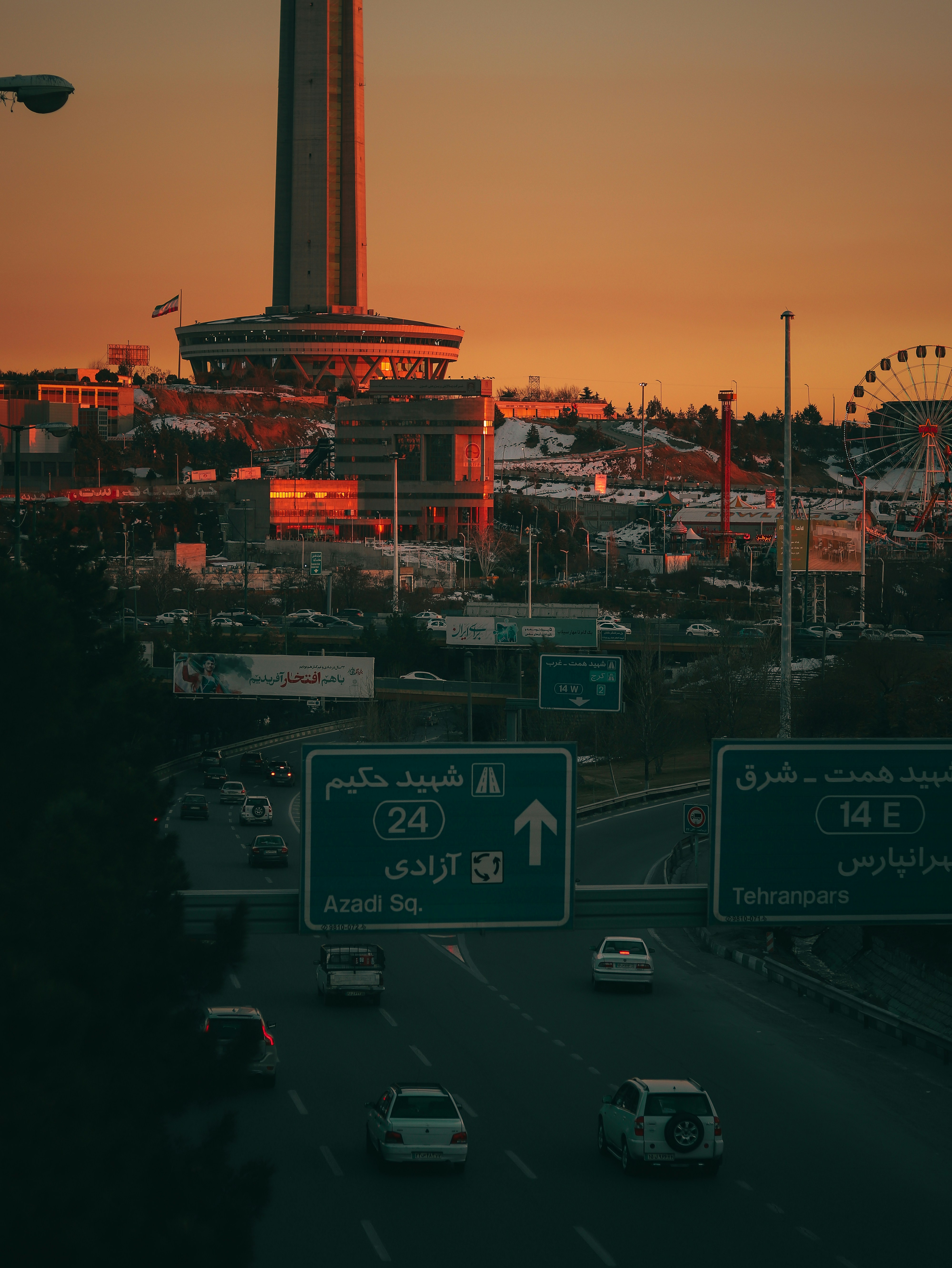 a view of a city with a tall building in the background
