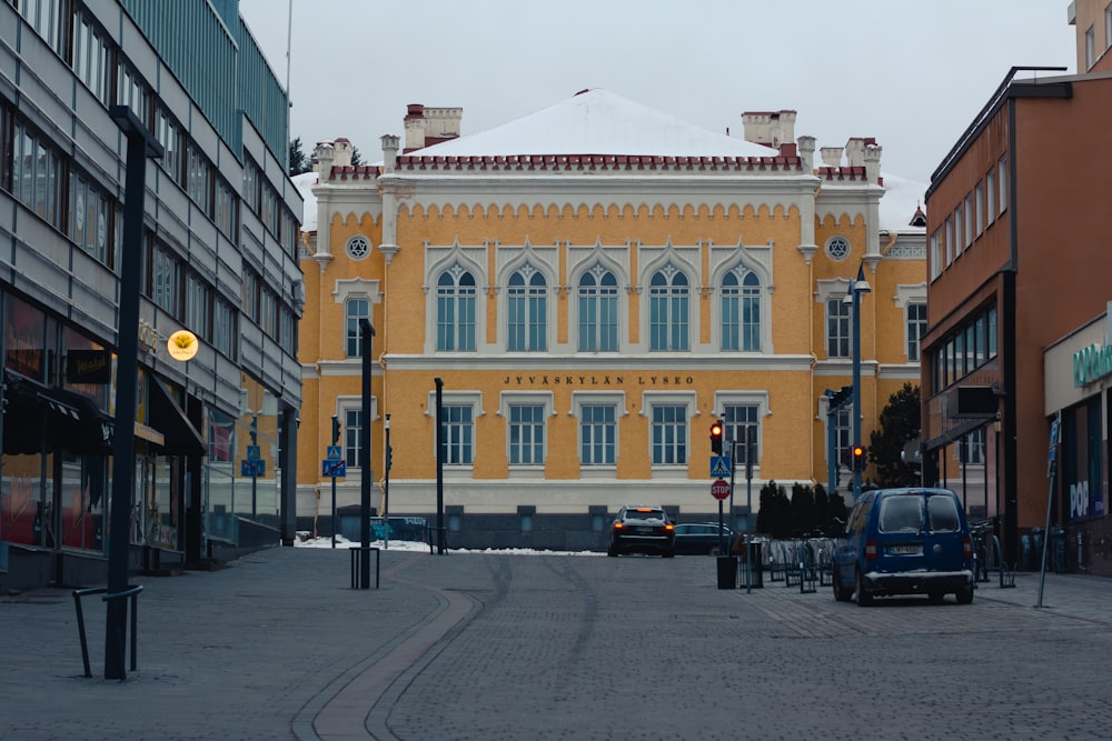 a yellow building with a clock on the front of it