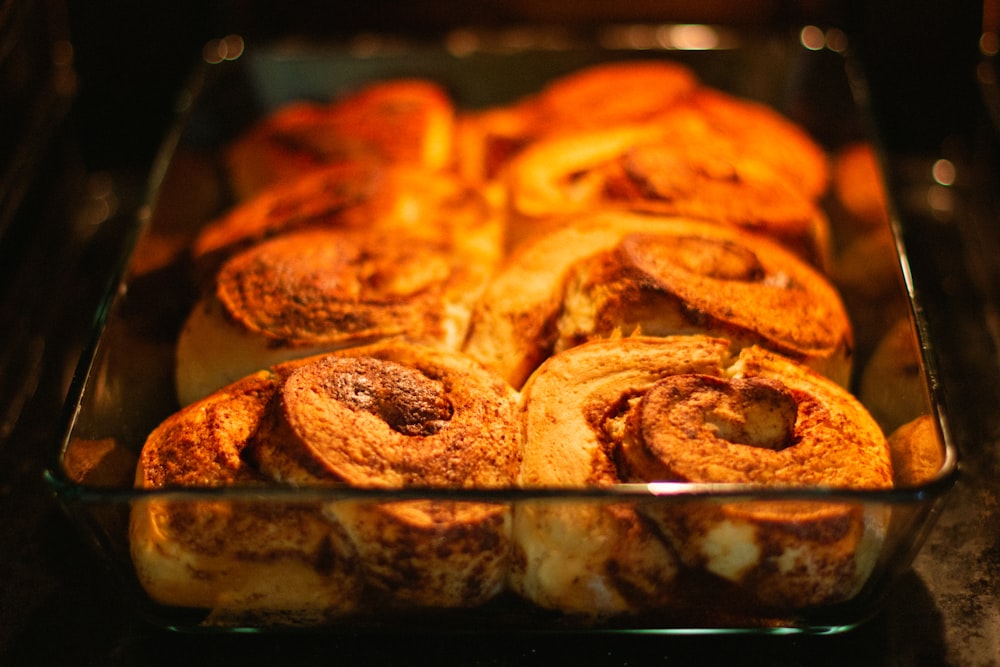 a glass baking dish filled with cinnamon rolls